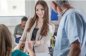 Woman paying for care at business desk