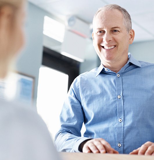 Smiling man at reception desk