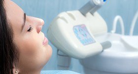 Relaxed woman with eyes closed in dental chair