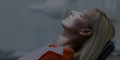 Relaxed woman receiving dental care