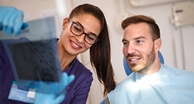 Dental staff talks to patient