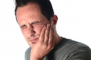man frowning from tooth pain